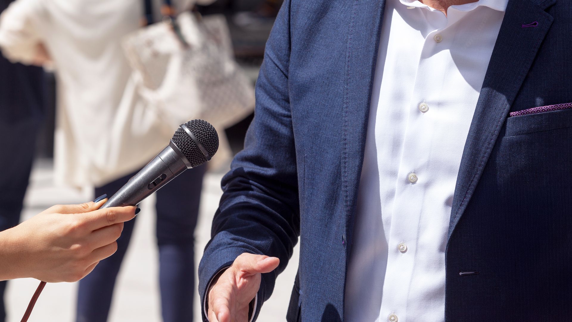 De torso van een man met een microfoon onder zijn neus - blog uitgeverij haystack